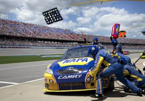 people changing tire of racing car increasing duration