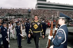 Nascar driver Michael Waltrip walks through Dover Air Force Base Honor Guard members as the drivers were announced before the MBNA 400 Winston Series race held at Dover Downs International Speedway, Dover, on September 24, 2000.